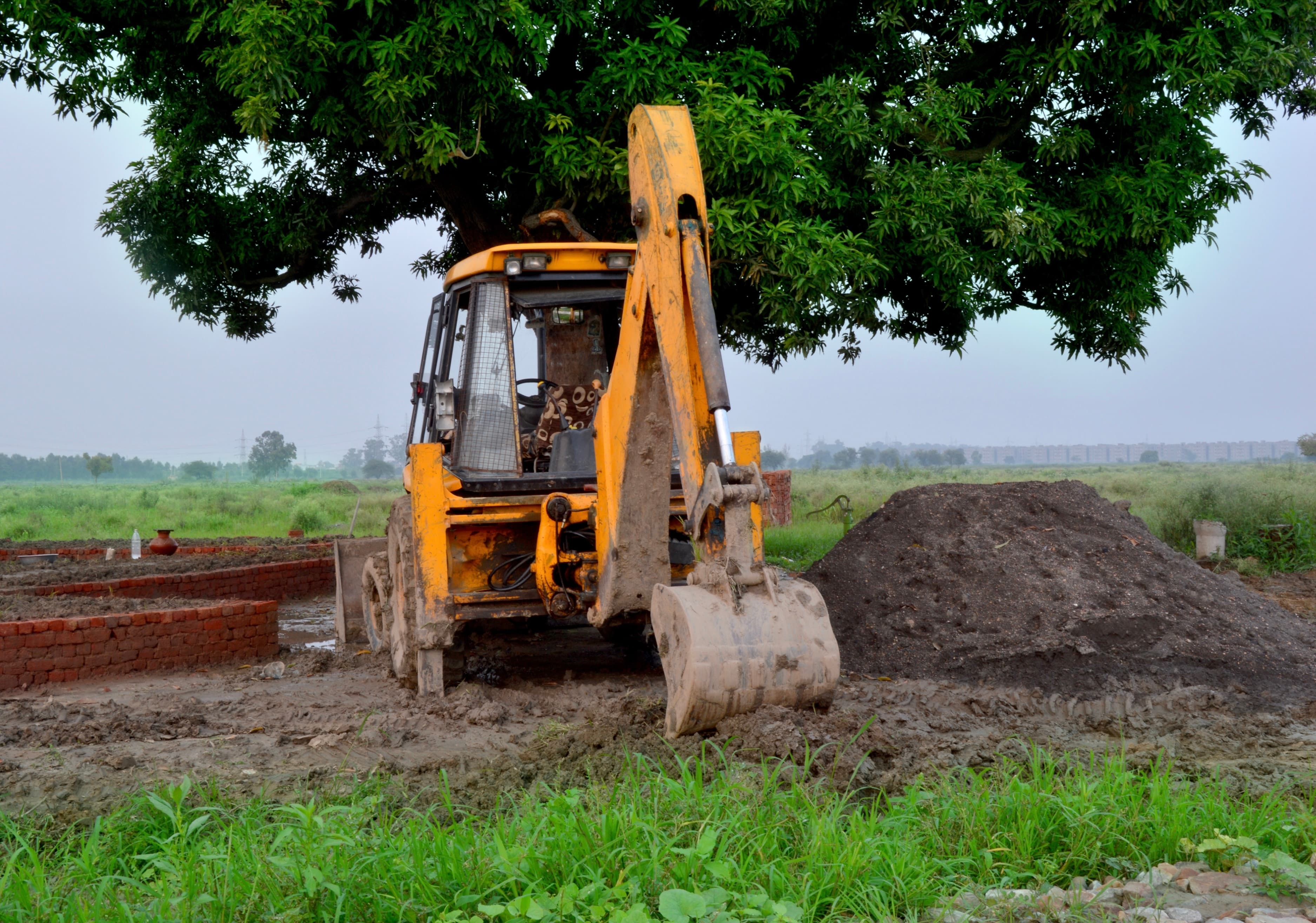 JCB earthmover on muddy construction site